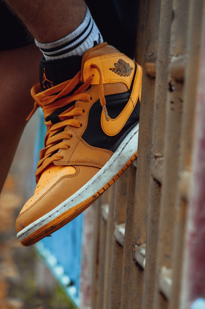 Dynamic close-up of an Air Jordan sneaker perched on a metal railing, showcasing design and style.
